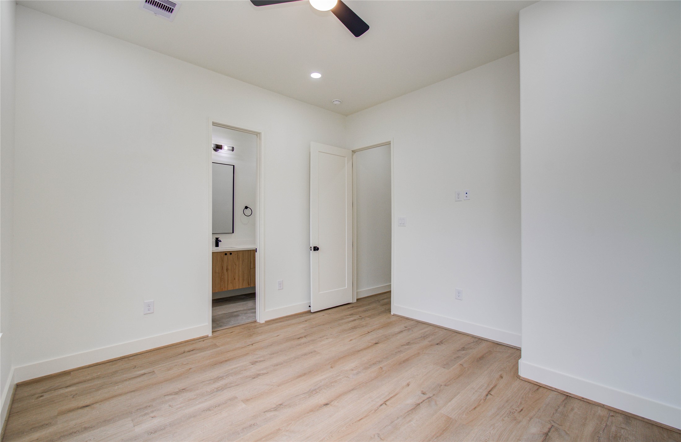 1815 McKee Street, Unit 1 Houston, TX 77009 - Photo 20 of 25 an empty room with wooden floor and windows