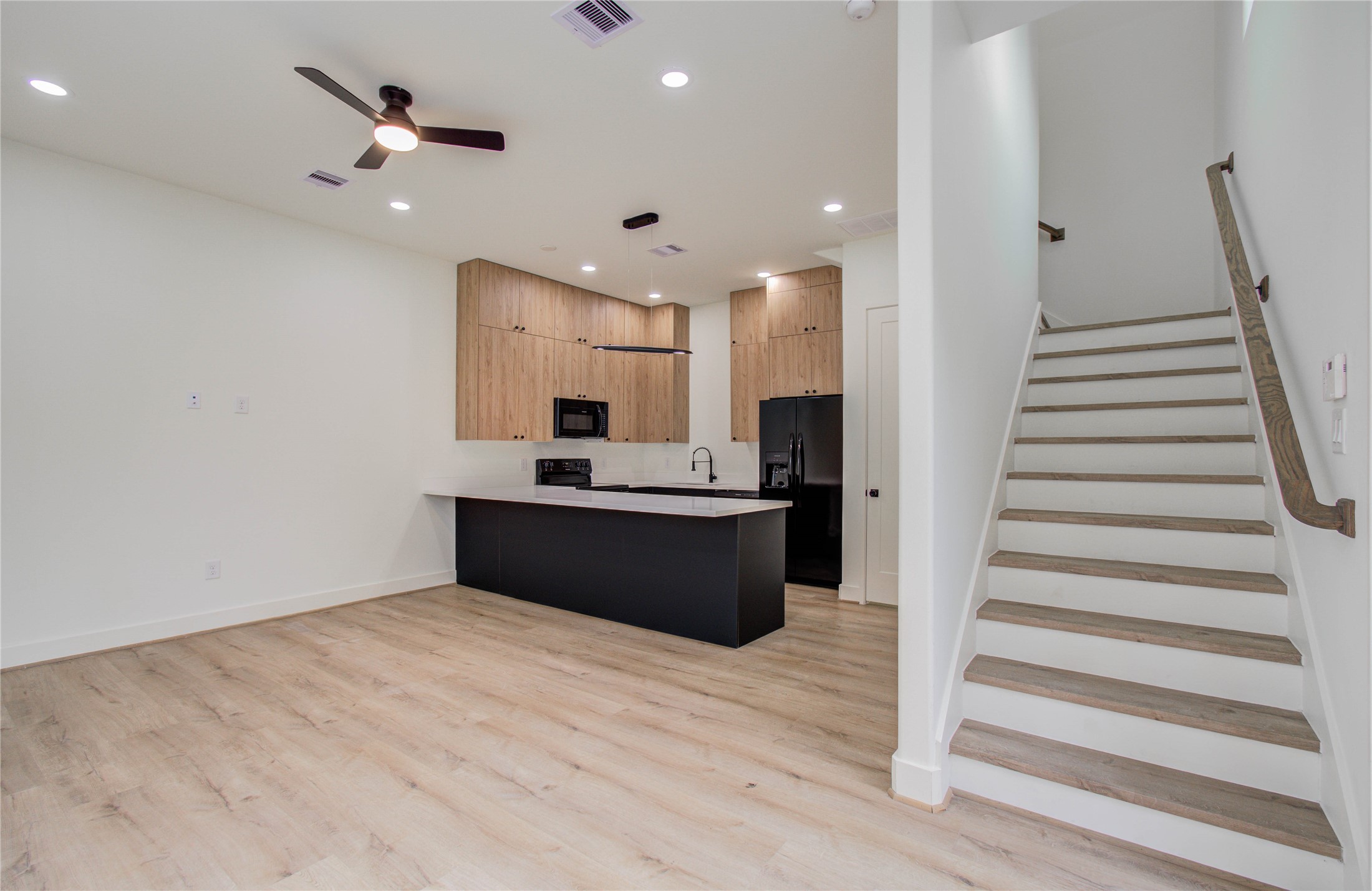 1815 McKee Street, Unit 1 Houston, TX 77009 - Photo 10 of 25 a kitchen with stainless steel appliances kitchen island wooden cabinets and fireplace