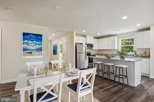 a kitchen with a refrigerator a sink and cabinets