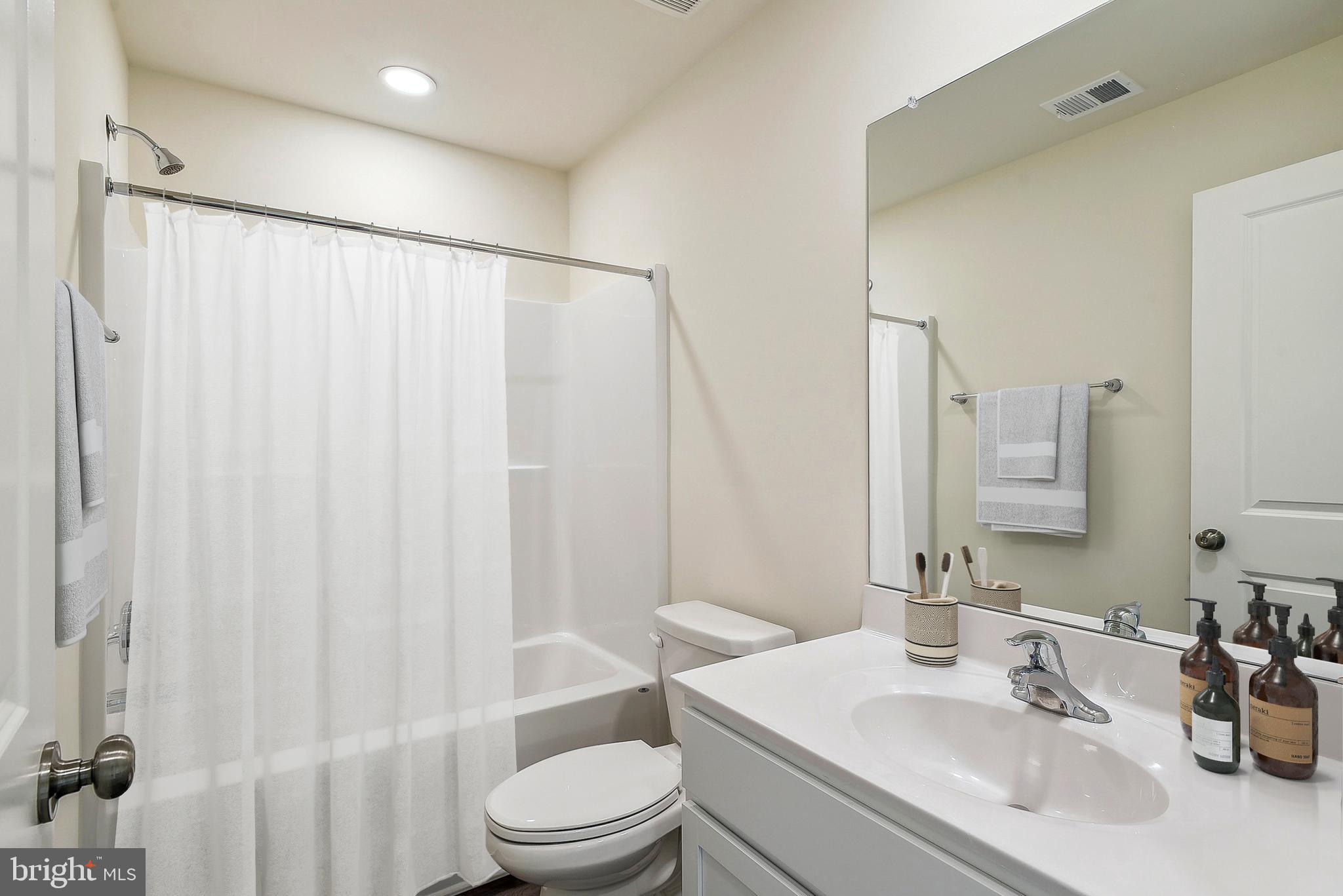 Ohio Avenue Earleville, MD 21919 - Photo 21 of 60 a bathroom with a sink a toilet and shower curtain