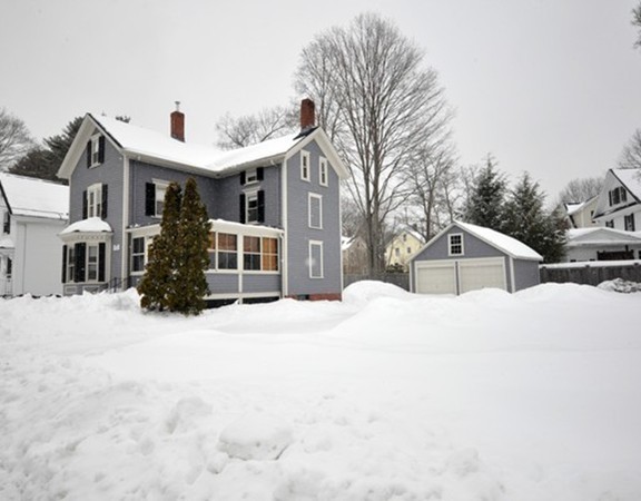 a front view of a house with a snow in front of it