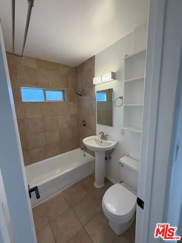 a bathroom with a sink a toilet and bathtub