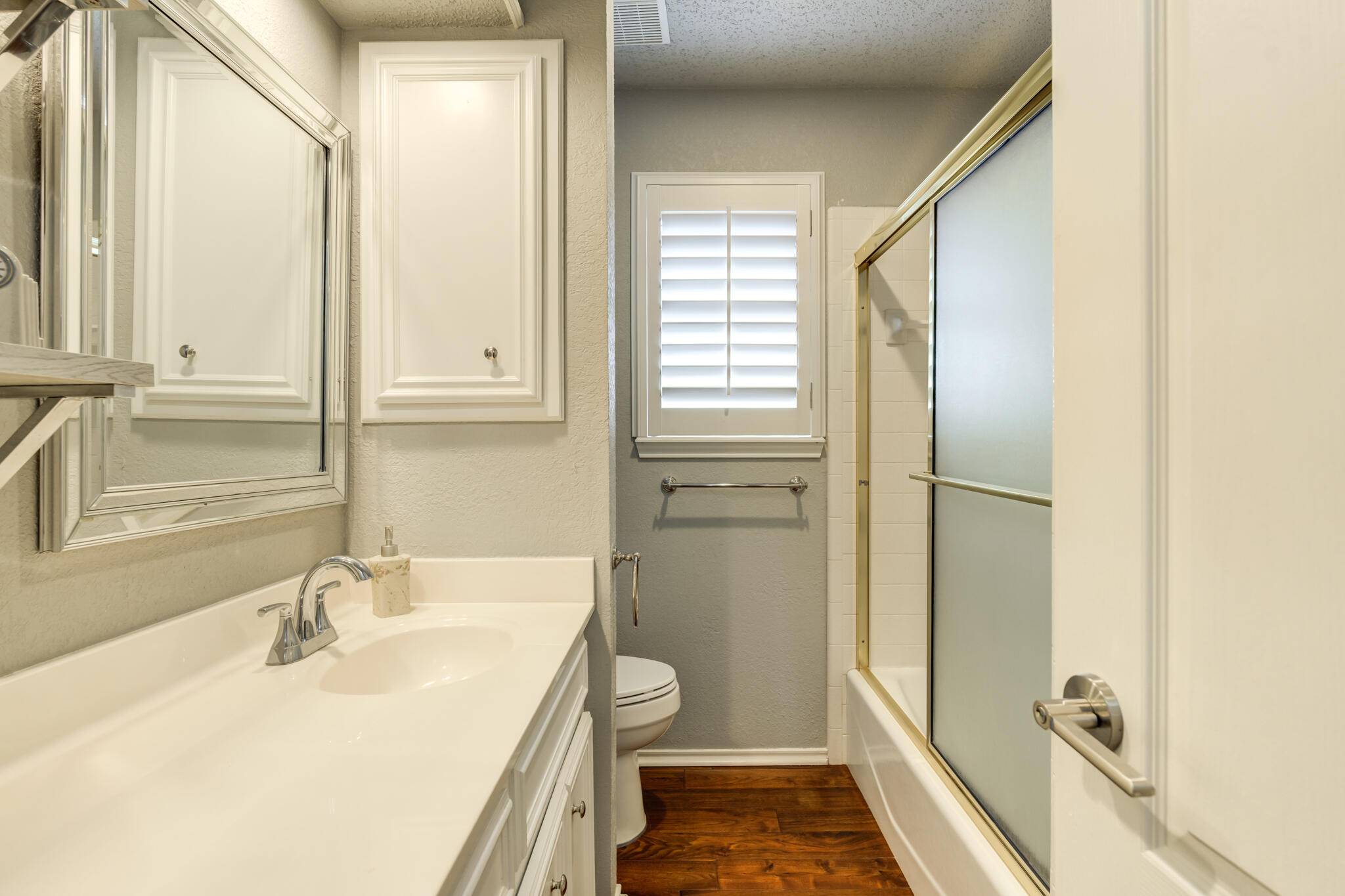 8204 Colton Avenue Lubbock, TX 79424 - Photo 12 of 19 a bathroom with a sink and a large mirror