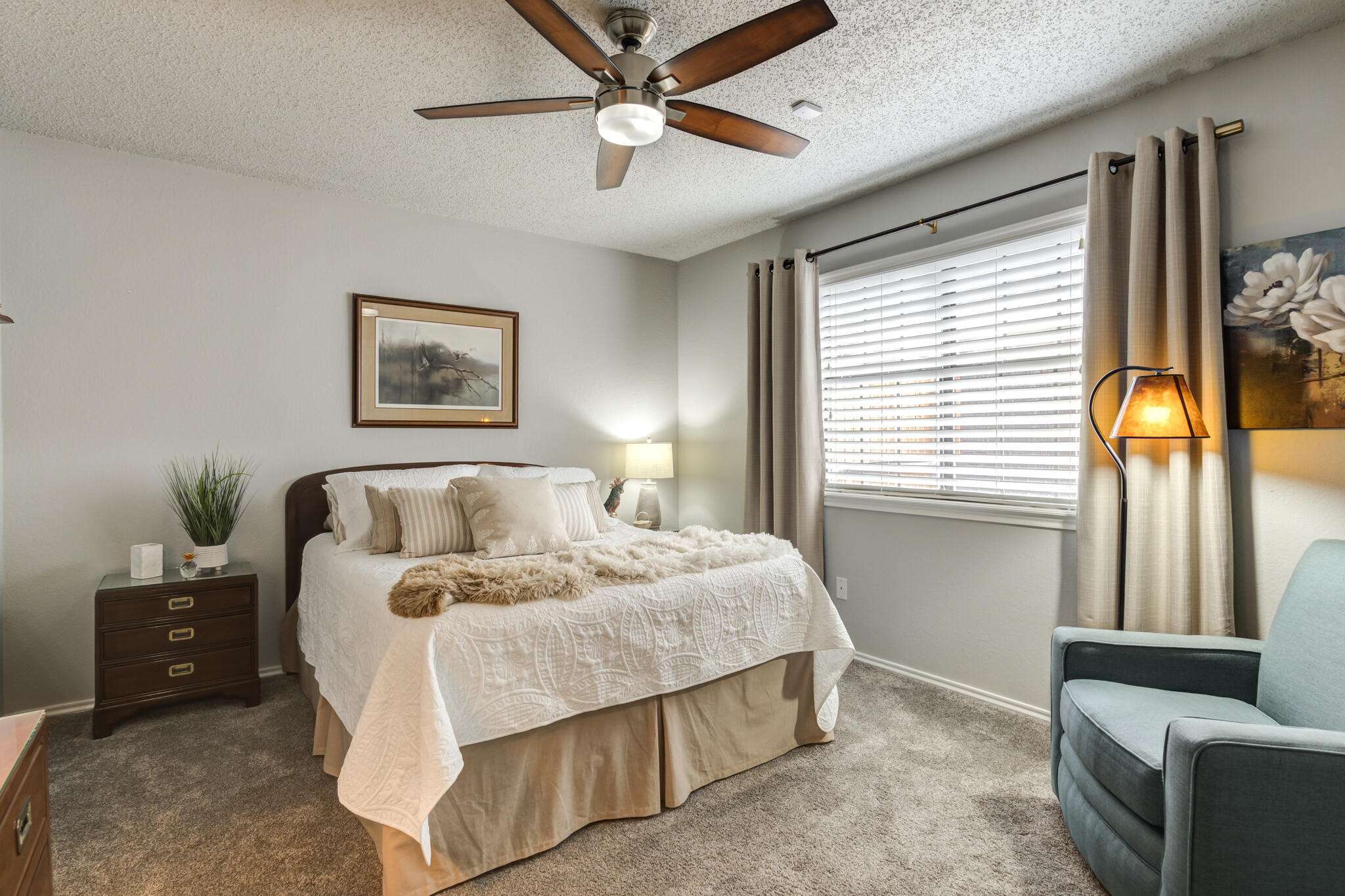 8204 Colton Avenue Lubbock, TX 79424 - Photo 13 of 19 a bedroom with a bed a couch and a window