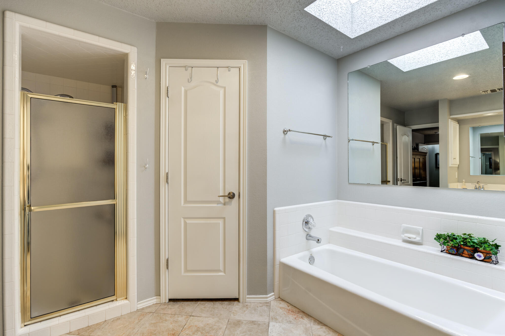 8204 Colton Avenue Lubbock, TX 79424 - Photo 14 of 19 a bathroom with a bathtub and a shower