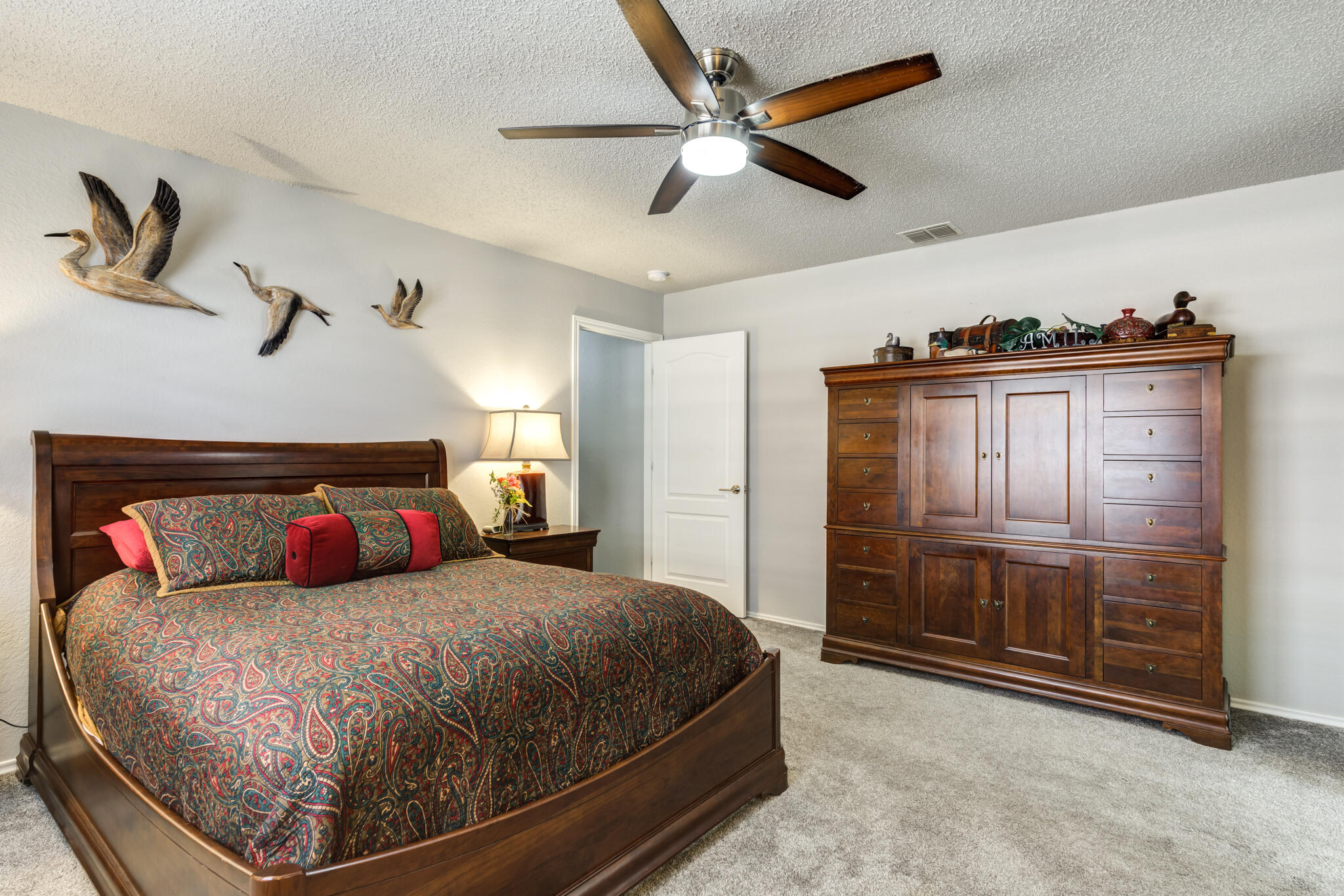 8204 Colton Avenue Lubbock, TX 79424 - Photo 15 of 19 a bedroom with a bed and a dresser