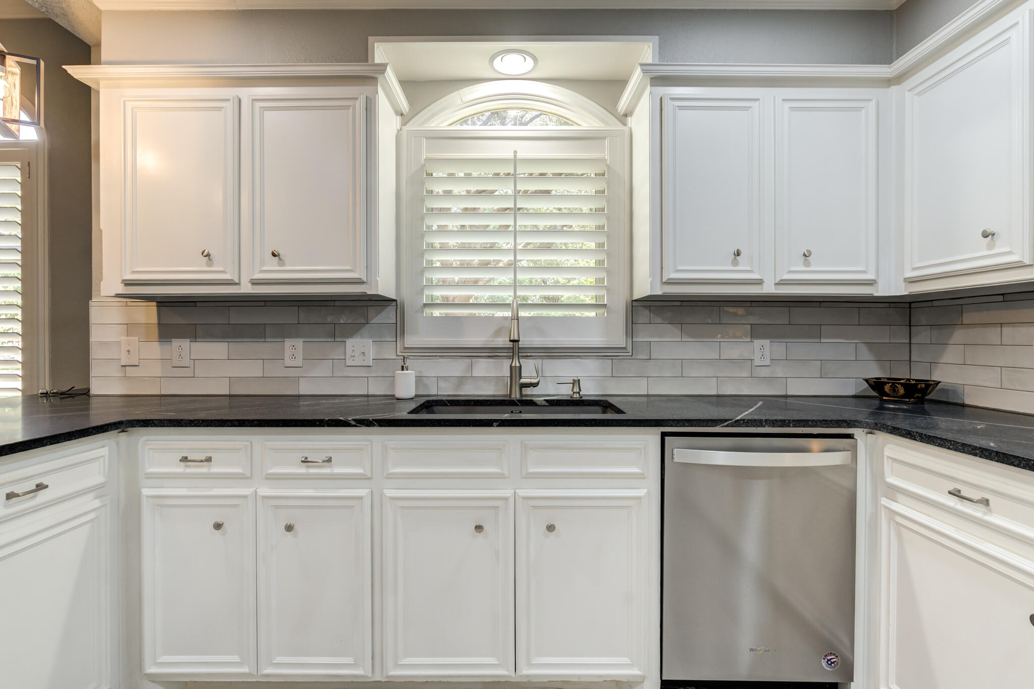 8204 Colton Avenue Lubbock, TX 79424 - Photo 4 of 19 a kitchen with granite countertop white cabinets and sink