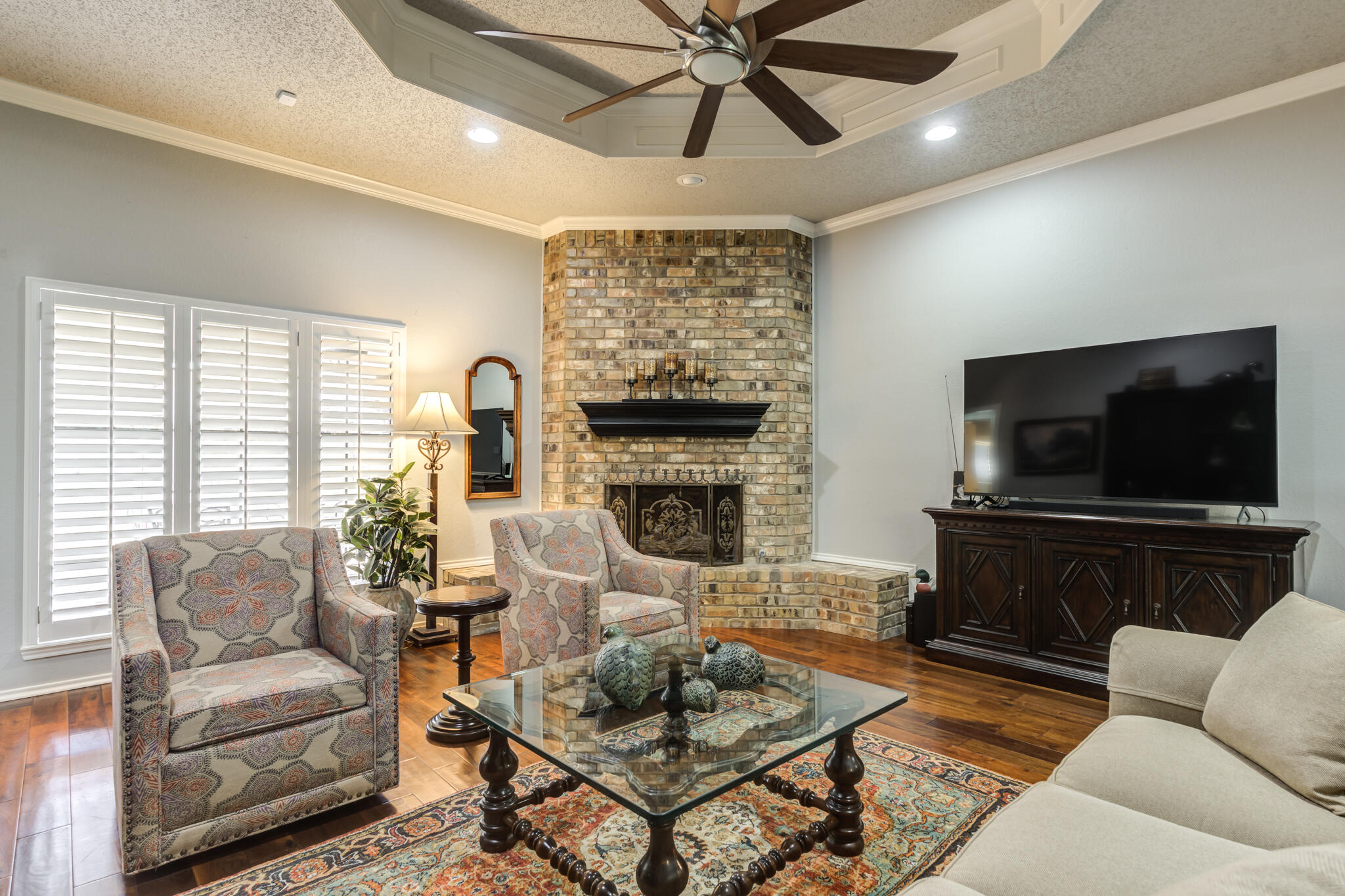8204 Colton Avenue Lubbock, TX 79424 - Photo 8 of 19 a living room with furniture a flat screen tv and a fireplace