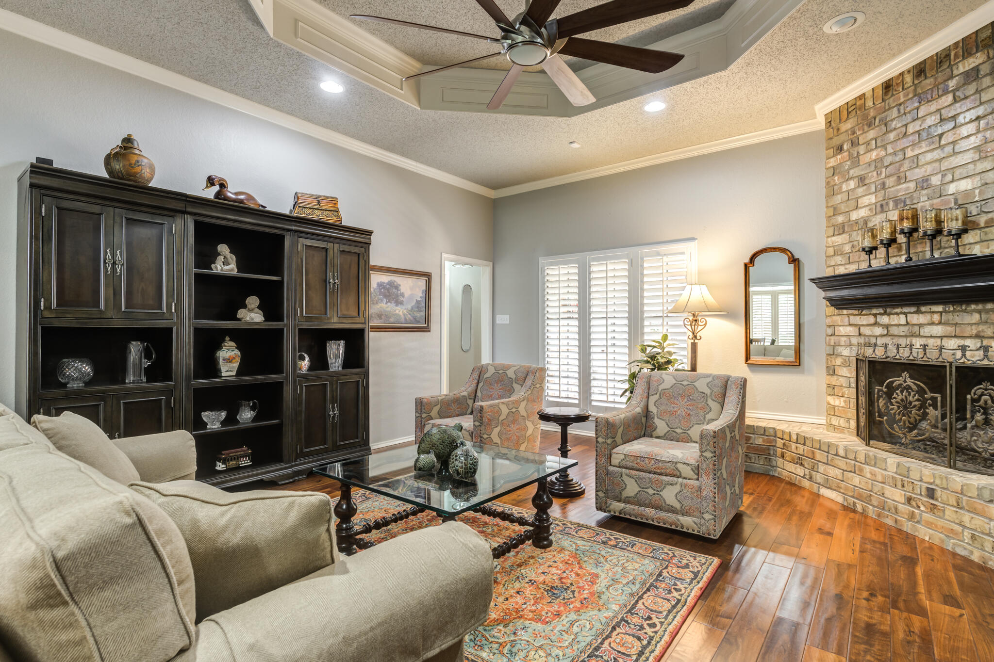 8204 Colton Avenue Lubbock, TX 79424 - Photo 9 of 19 a living room with furniture a fireplace and a flat screen tv