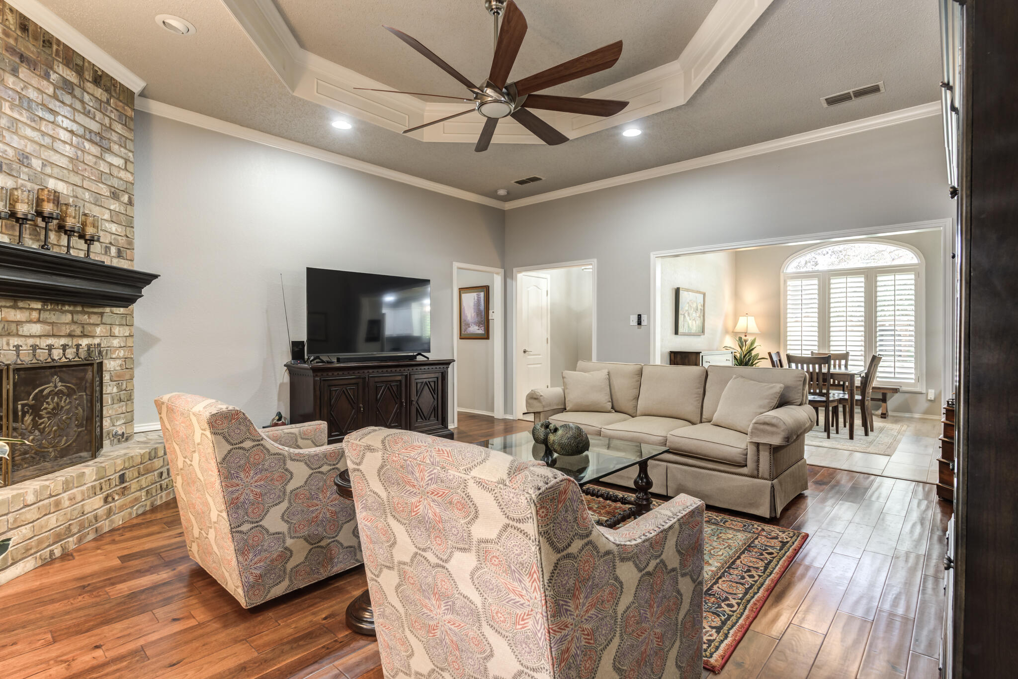 8204 Colton Avenue Lubbock, TX 79424 - Photo 10 of 19 a living room with furniture a fireplace and a flat screen tv