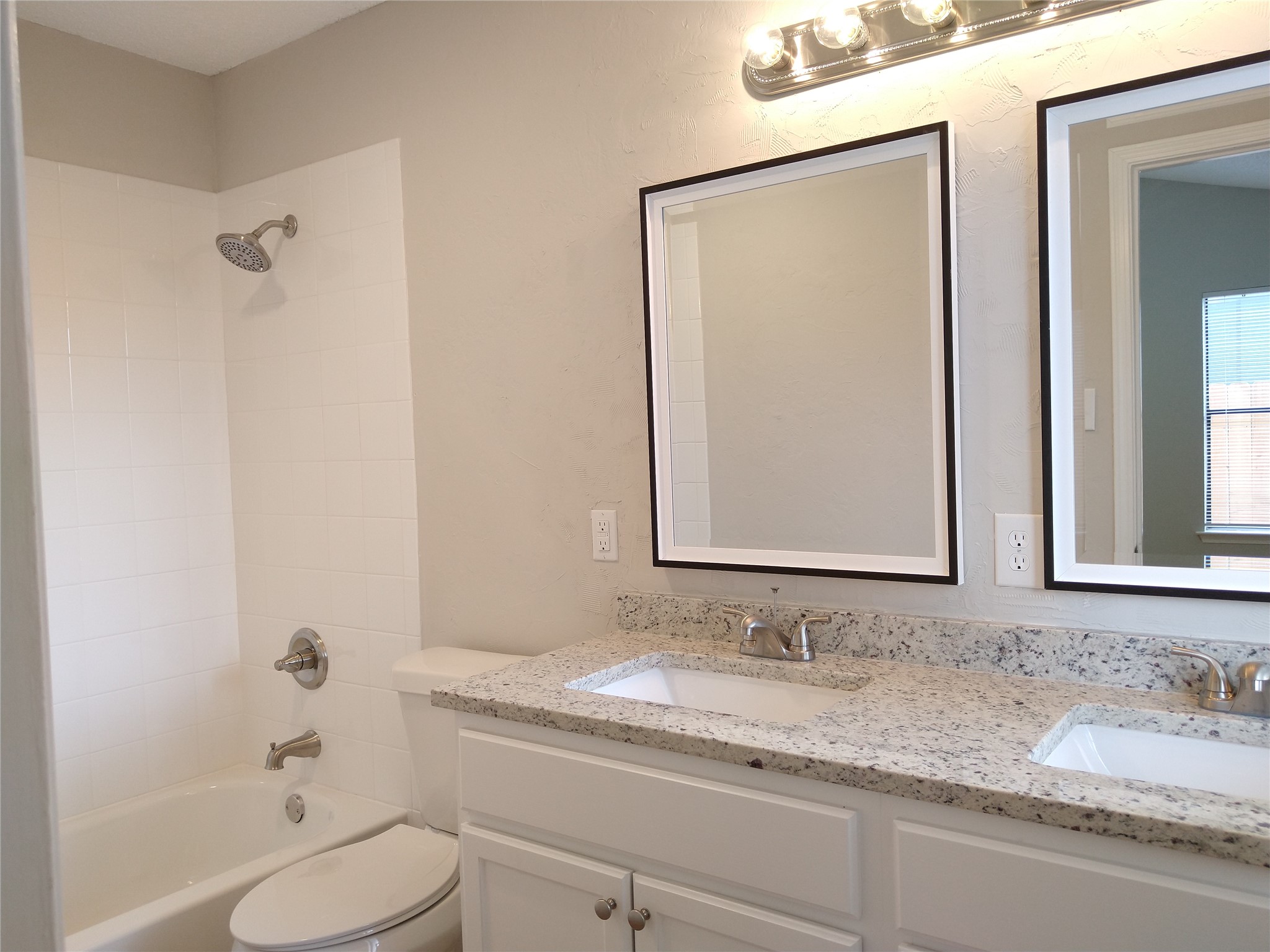 1813 Laurel Path Round Rock, TX 78664 - Photo 27 of 35 Double vanity with granite counters complements the clean tiled shower and bathtub.