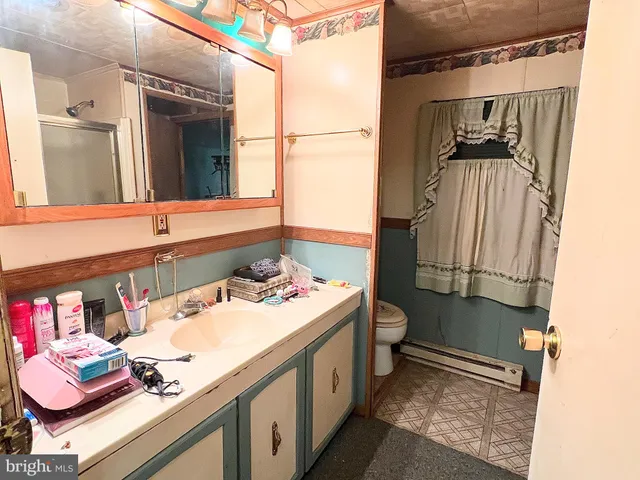 a living room with furniture a rug and white walls