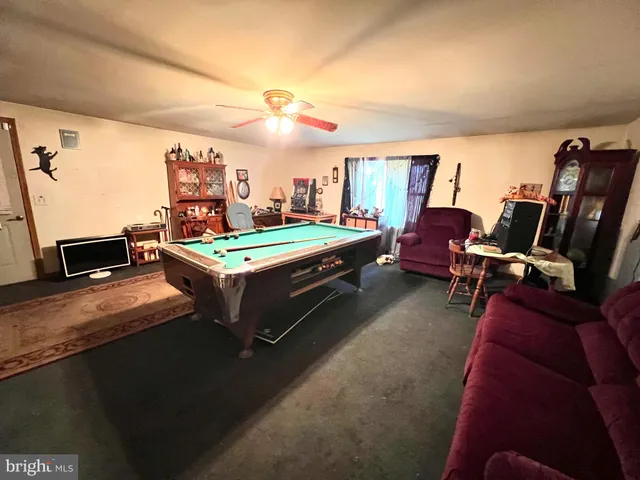 a room with furniture a flat screen tv and a large window