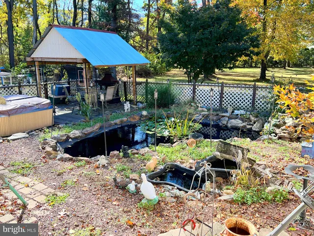 an outdoor sitting area with furniture and umbrella