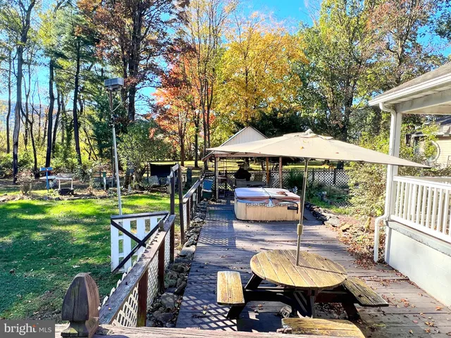 a view of a swimming pool with a patio and fire pit