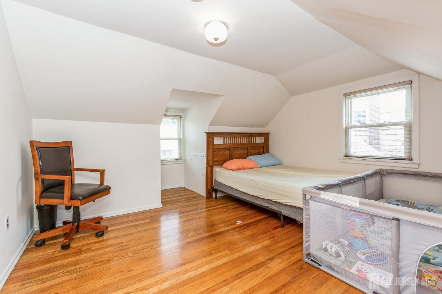 8 Longfellow Drive Colonia, NJ 07067 - Photo 17 of 24 a bedroom with a bed and wooden floor