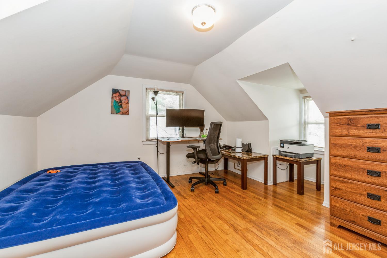 8 Longfellow Drive Colonia, NJ 07067 - Photo 20 of 24 a bedroom with furniture and a wooden floor