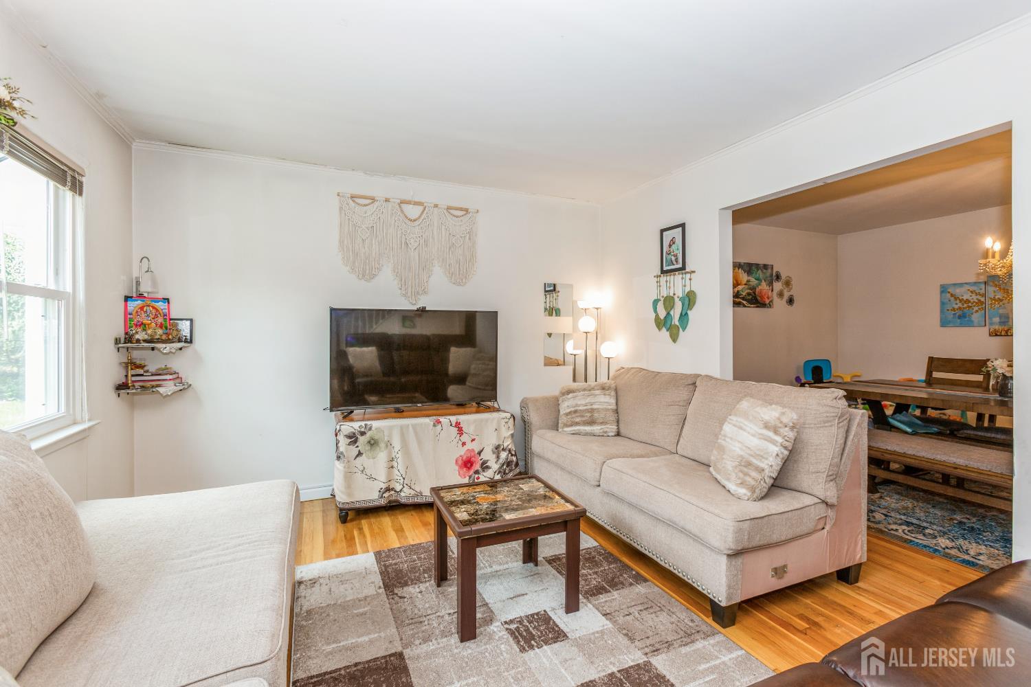 8 Longfellow Drive Colonia, NJ 07067 - Photo 2 of 24 a living room with furniture and a flat screen tv