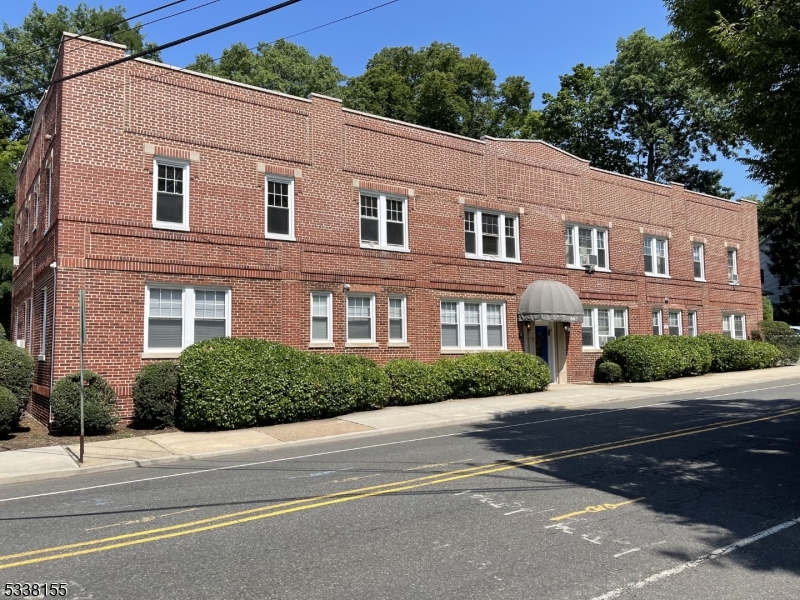 665 Ridgewood Road, Unit 8 Millburn, NJ 07041 - Photo 1 of 10 a front view of a house with a yard