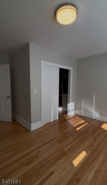 665 Ridgewood Road, Unit 8 Millburn, NJ 07041 - Photo 6 of 10 a view of empty room with wooden floor