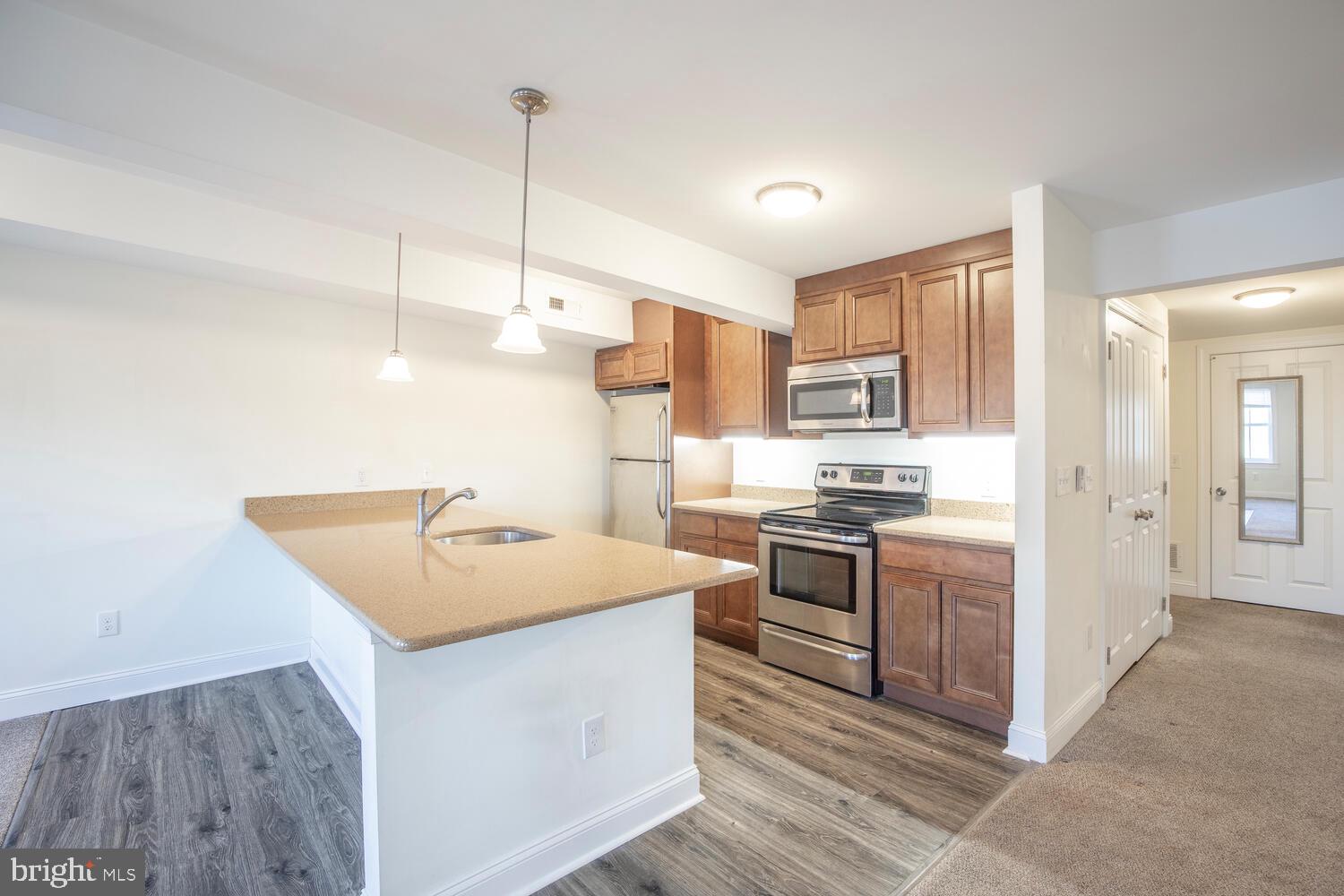 30 West State Street, Unit B Doylestown, PA 18901 - Photo 1 of 27 a kitchen with stainless steel appliances granite countertop a sink a stove and a refrigerator