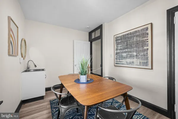 a dining room with furniture and wooden floor