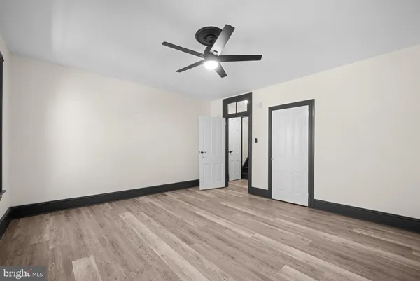 a view of empty room with wooden floor