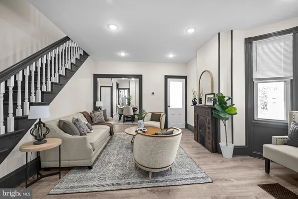 a living room with furniture and a potted plant