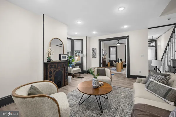 a living room with furniture and wooden floor