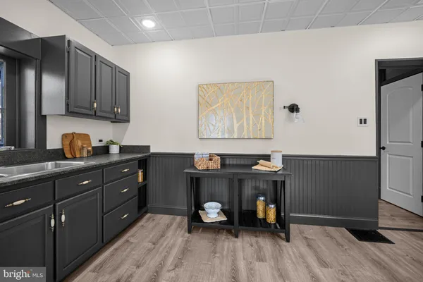 a kitchen with cabinets and wooden floor