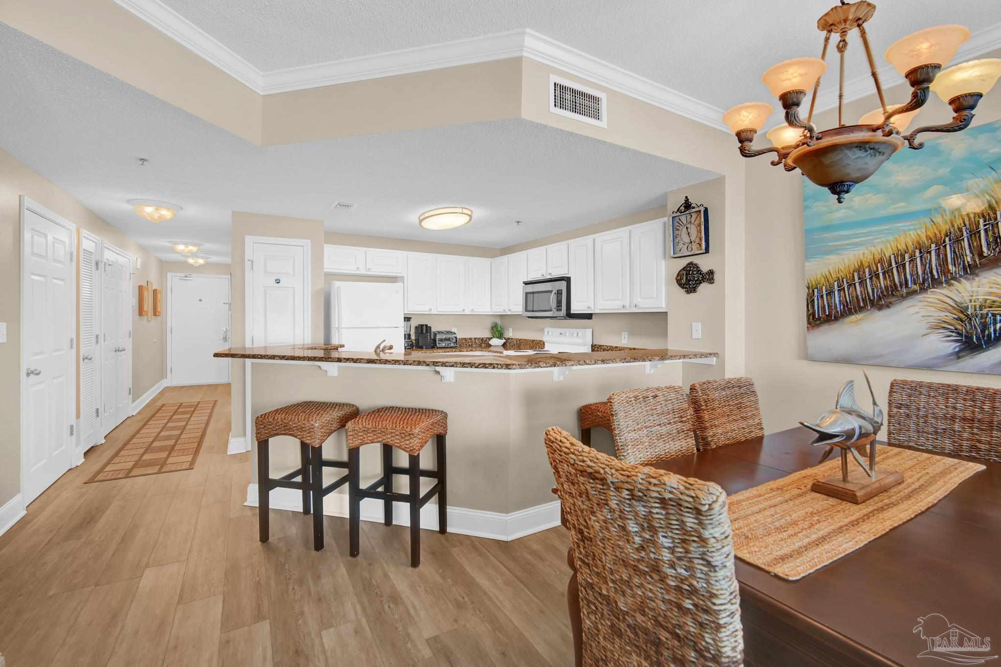 13661 Perdido Key Drive, Unit 1603 Perdido Key, FL 32507 - Photo 13 of 50 a dining room with furniture and wooden floor