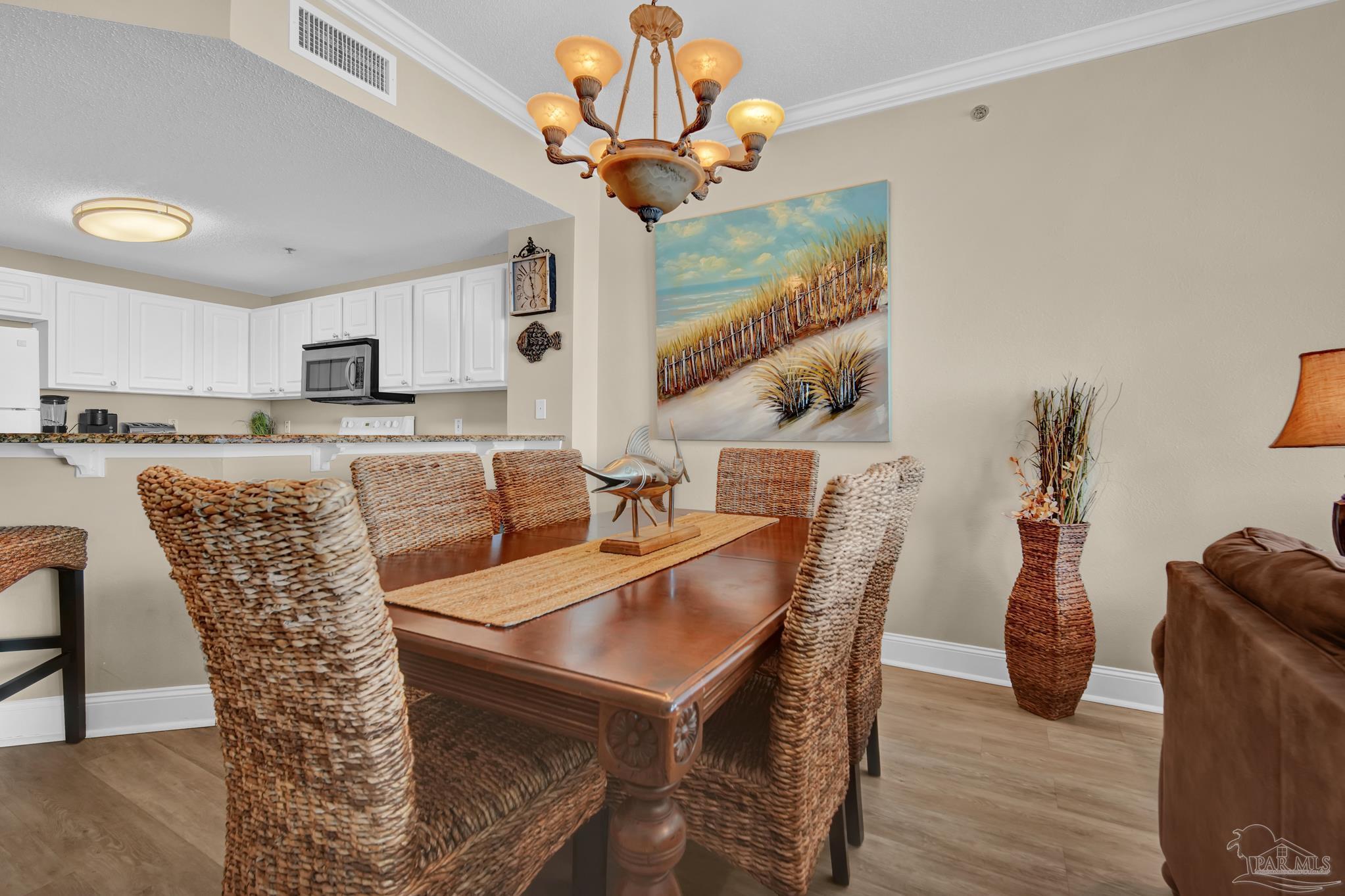 13661 Perdido Key Drive, Unit 1603 Perdido Key, FL 32507 - Photo 15 of 50 a view of a dining room with furniture and wooden floor