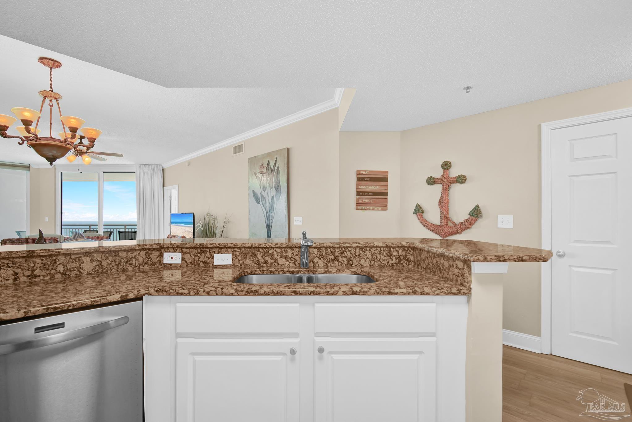 13661 Perdido Key Drive, Unit 1603 Perdido Key, FL 32507 - Photo 19 of 50 a kitchen with granite countertop a sink and cabinets