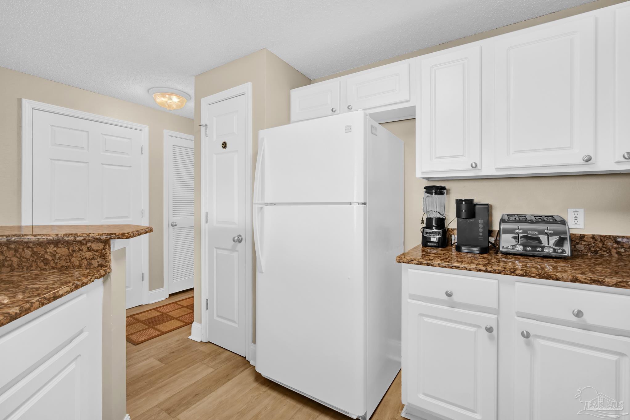 13661 Perdido Key Drive, Unit 1603 Perdido Key, FL 32507 - Photo 20 of 50 a white refrigerator freezer sitting inside of a kitchen