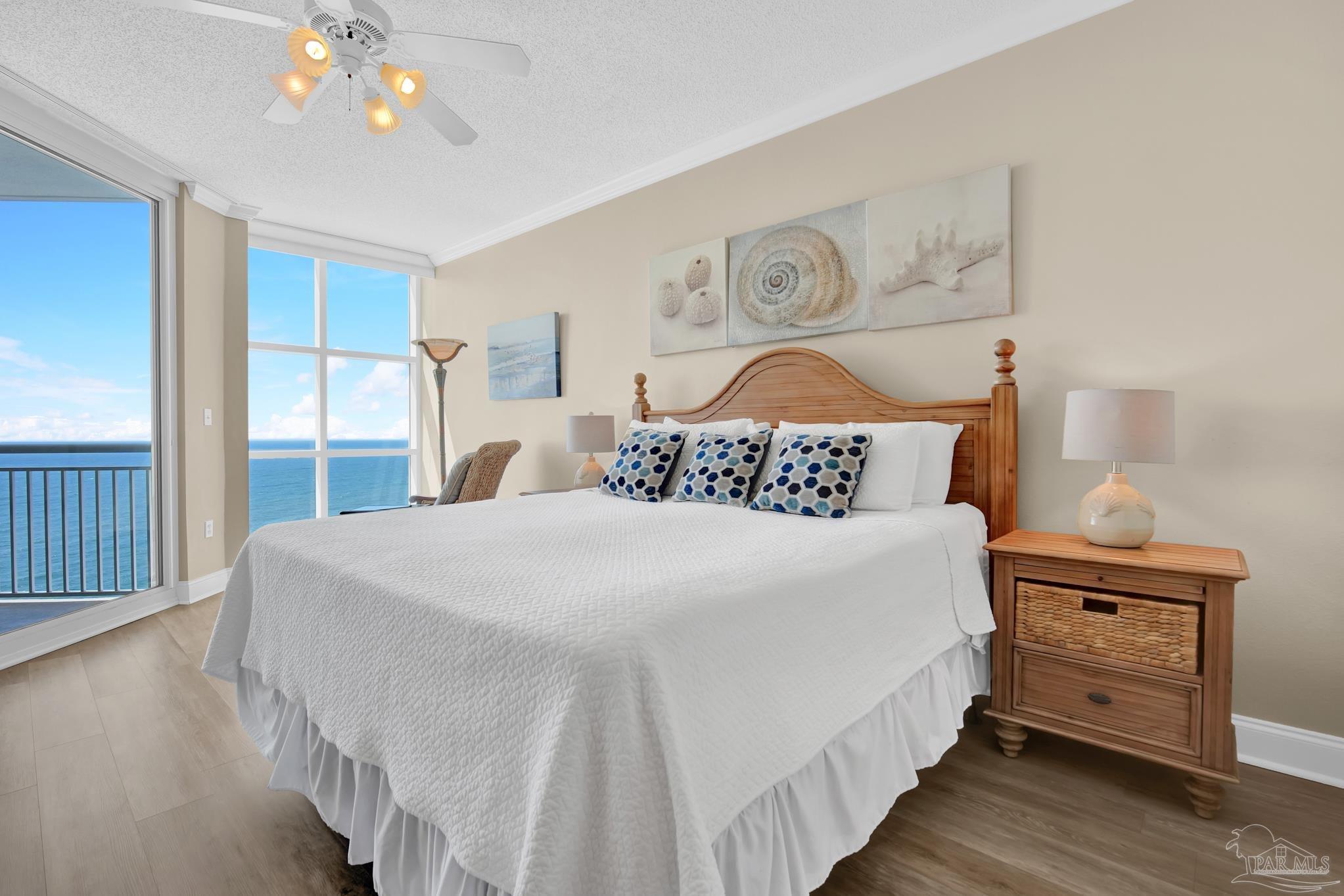 13661 Perdido Key Drive, Unit 1603 Perdido Key, FL 32507 - Photo 21 of 50 a bedroom with a large bed and a chandelier