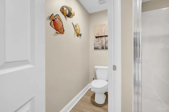 a bathroom with a toilet and a shower