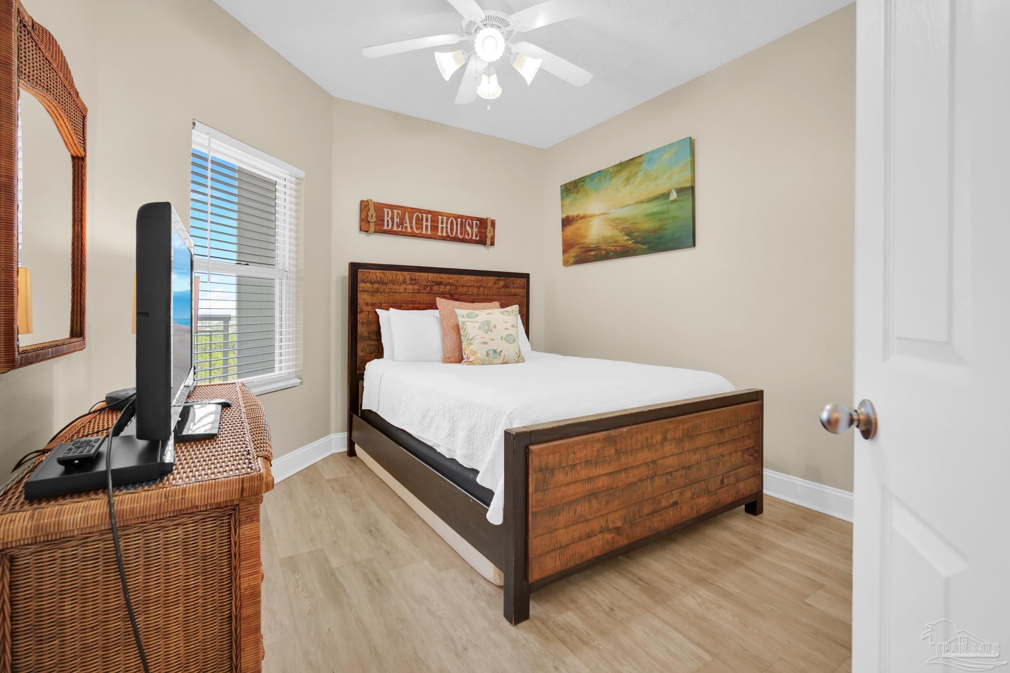 13661 Perdido Key Drive, Unit 1603 Perdido Key, FL 32507 - Photo 32 of 50 a bedroom with a bed and a flat tv screen on dresser