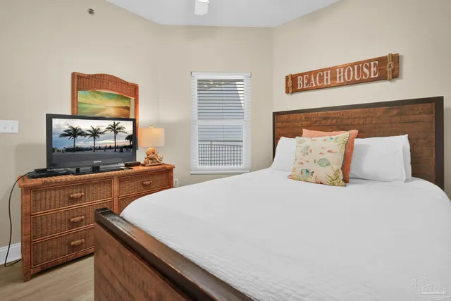 a bedroom with a bed and a television