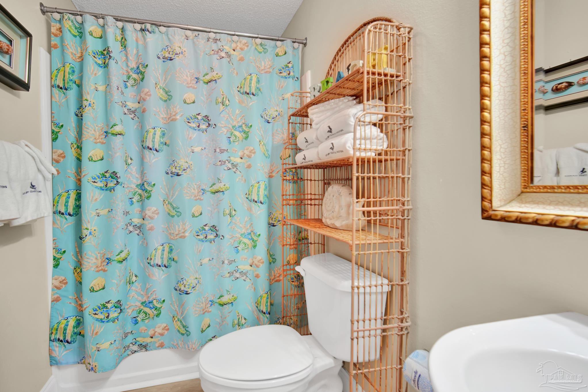 13661 Perdido Key Drive, Unit 1603 Perdido Key, FL 32507 - Photo 35 of 50 a white toilet sitting next to a shower curtain