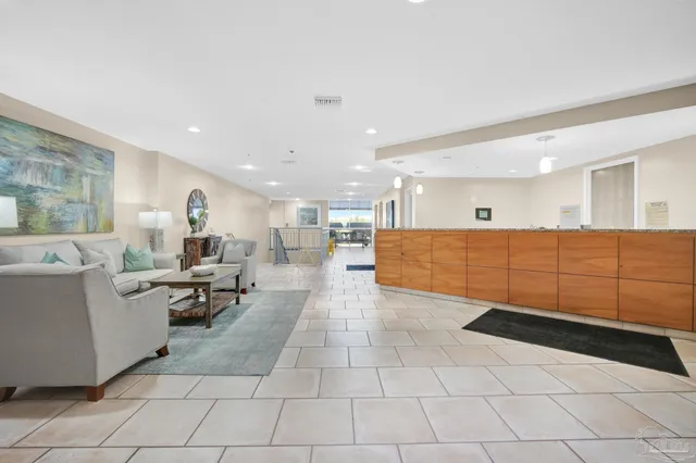 a living room with couches and kitchen view