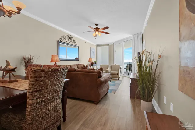 a living room with furniture a wooden floor and a chandelier