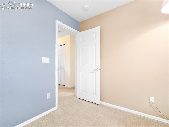 5346 Gentle Wind Road Colorado Springs, CO 80922 - Photo 15 of 28 Spare room featuring light colored carpet and baseboards