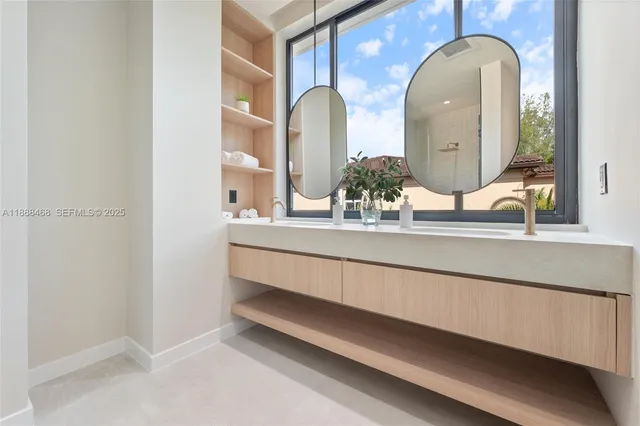 a bathroom with a double vanity sink and a mirror