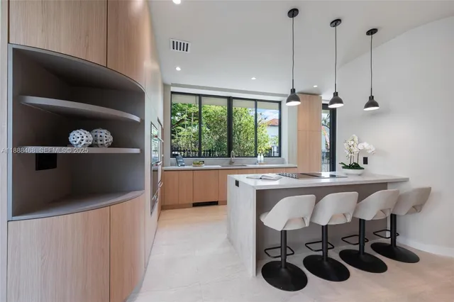 a kitchen with stainless steel appliances a sink a stove and a wooden floor