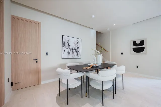 a living room with furniture and a painting on the wall