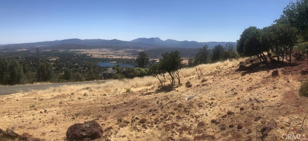 15927 Eagle Rock Road Hidden Valley Lake, CA 95467 - Photo 2 of 65 a view of a dry yard with mountains in the background