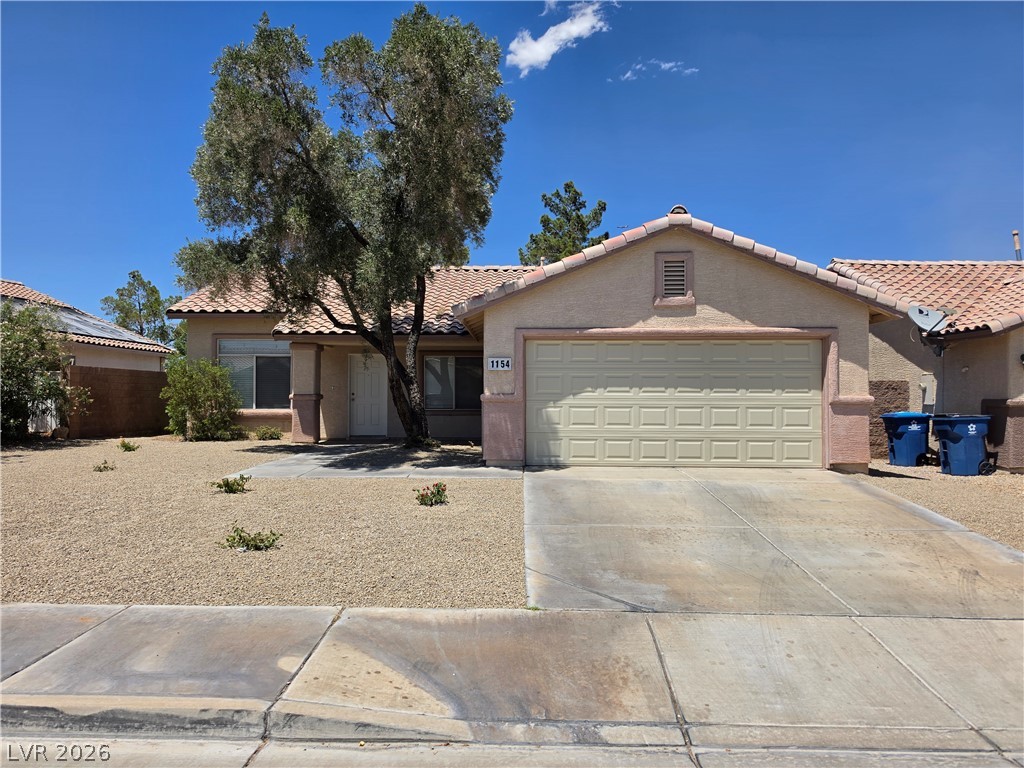 1154 Point Success Avenue Henderson, NV 89014 - Photo 26 of 26 A classic facade with a tan stucco finish and a terracotta tile roof presents a warm, inviting curb appeal.