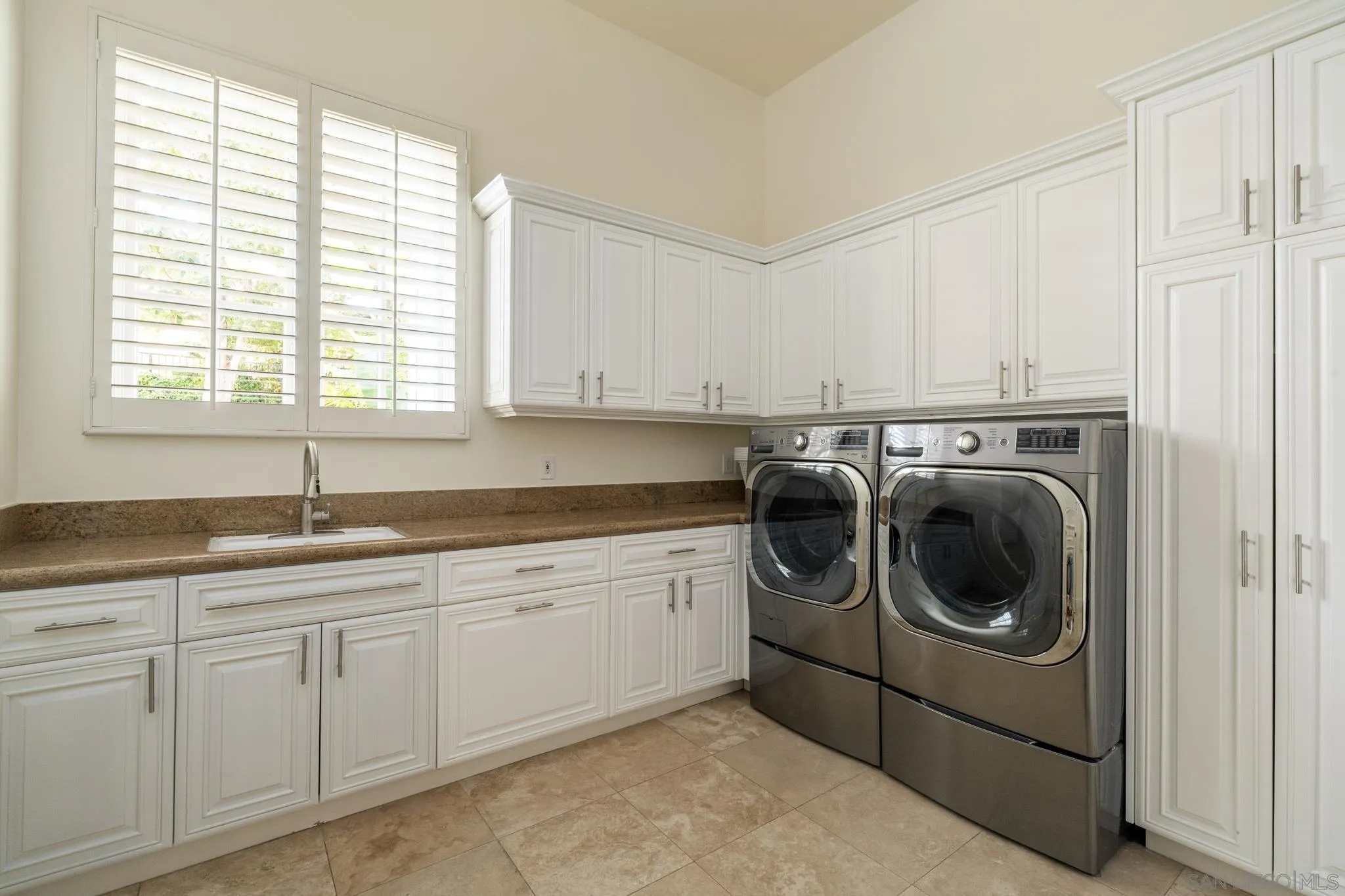 6369 Clubhouse Rancho Santa Fe, CA 92067 - Photo 32 of 43 a utility room with sink dryer and washer