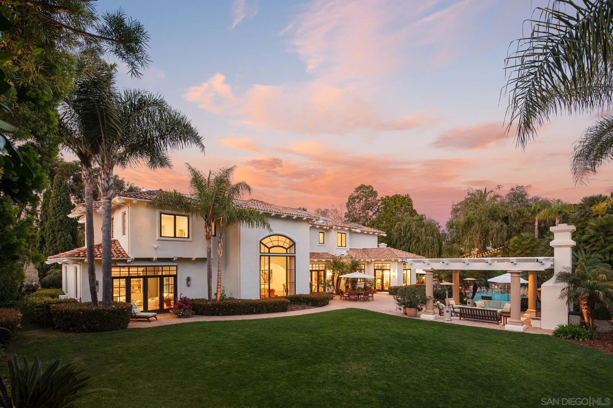 6369 Clubhouse Rancho Santa Fe, CA 92067 - Photo 34 of 43 a front view of a house with a garden and trees