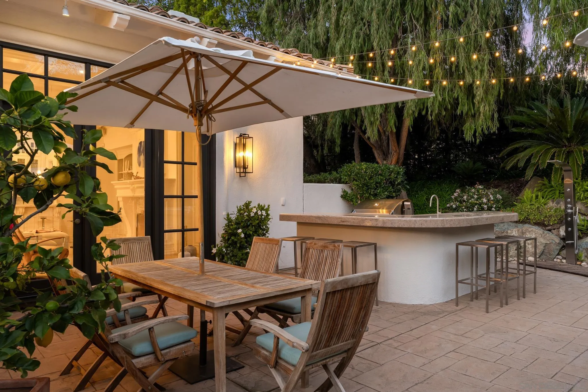 6369 Clubhouse Rancho Santa Fe, CA 92067 - Photo 9 of 43 a view of a patio with table and chairs under an umbrella
